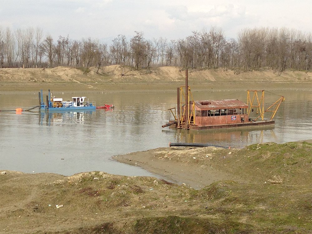 A modern ellicott brand dredge alongside a 50 year old model in the jhelum river in kashmir